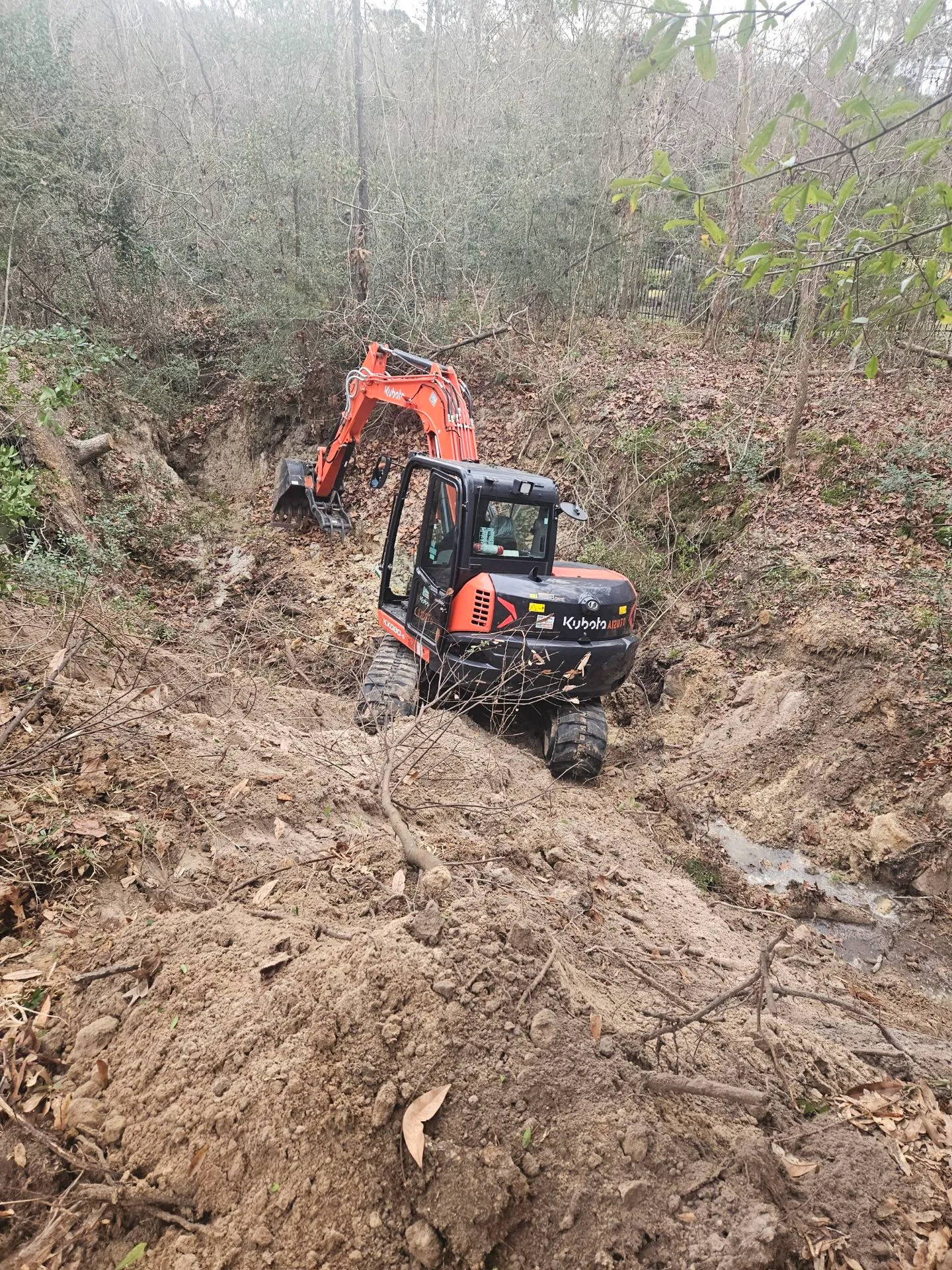 Crew finishing creek-side paver edges